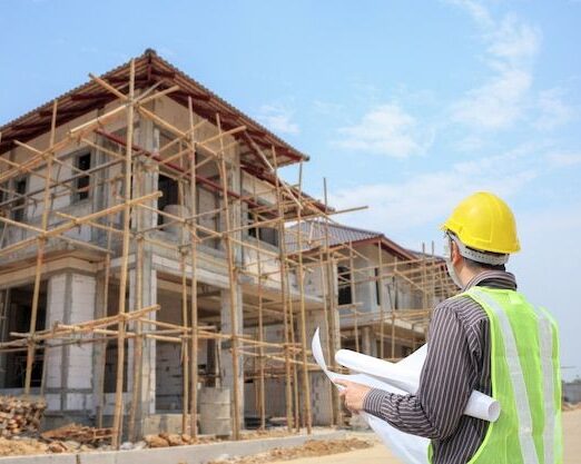 Premium Photo _ Young business man professional engineer worker at the house building construction site with blueprint